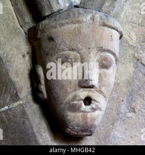 A carved head in St. Matthew`s Church, Coates, Gloucestershire, England, UK Stock Photo